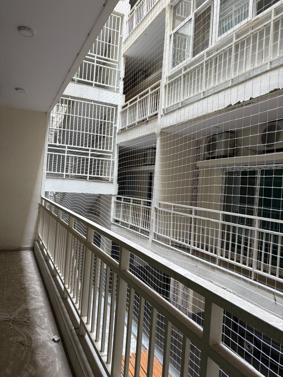 White net across society balcony voids facing a courtyard